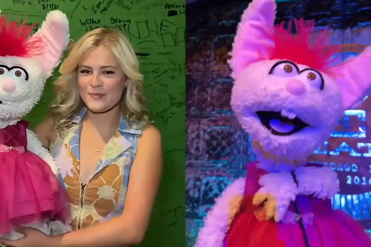 Costumed mascot and woman at Viral Music FM event in vibrant setting.