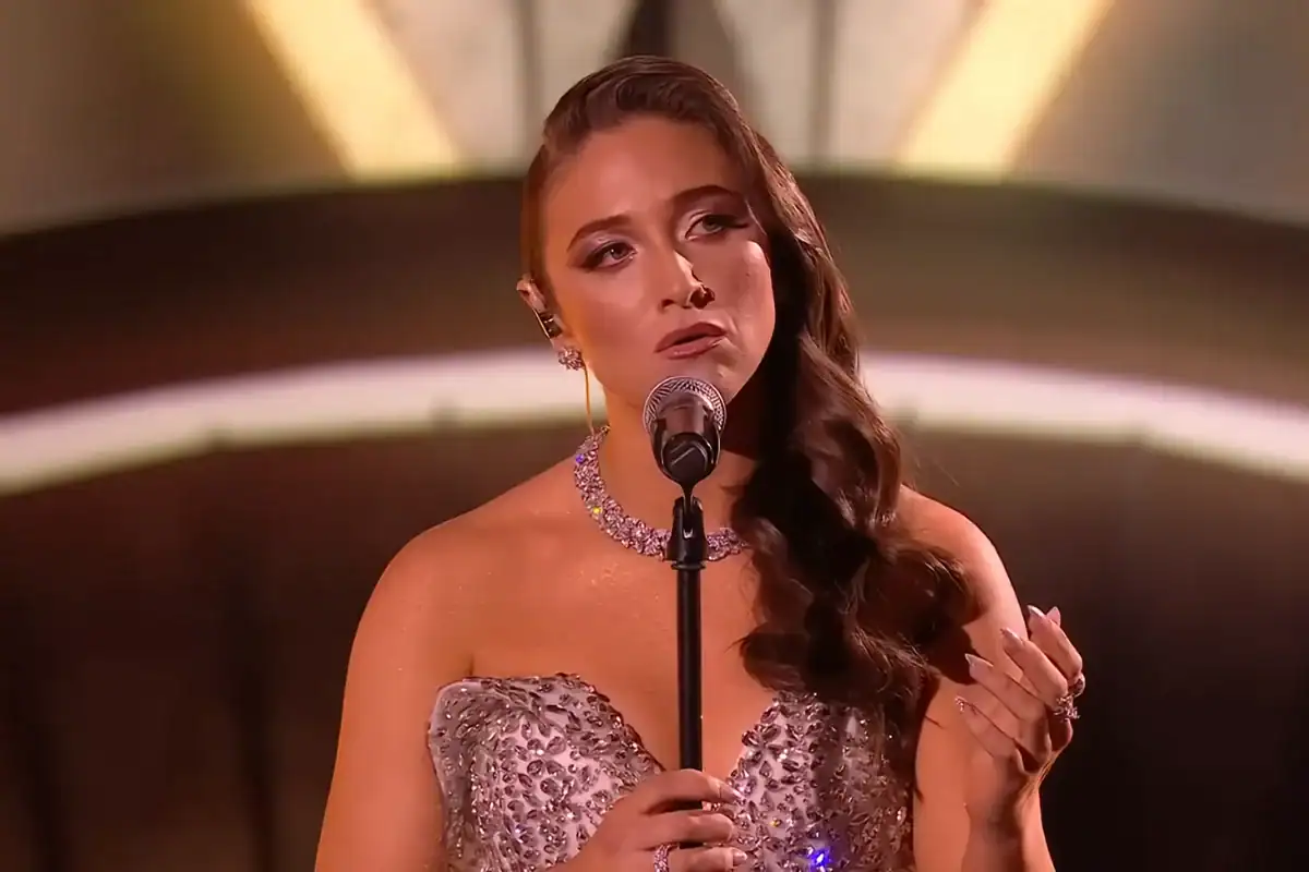 Female singer singing on stage with microphone at Viral Music FM event.